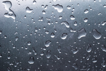 Drops of water on a gray background closeup