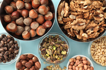 Bowls with different nuts on table