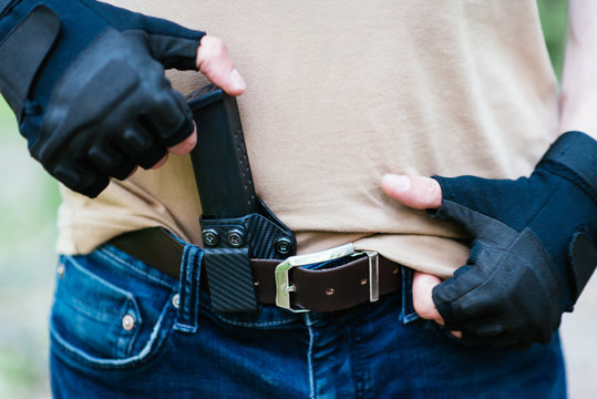 the guy puts a magazine from the gun in his holster