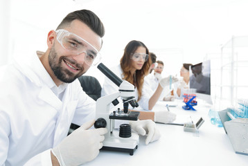Fototapeta premium closeup of male technician sitting at his working in the laboratory