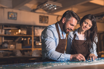 Smiling people in aprons at work