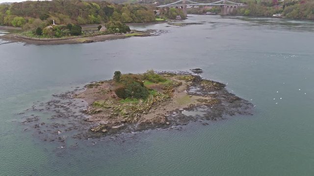 Bird and church Island with the Menai Bridge and the Straits at sunset Isle of Anglesey North Wales