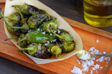 Pimientos de padron  or  Padron peppers, fried green peppers in olive oil and sprinkled with sea salt. This Galician snack is one of the most classic Spanish tapas.