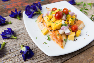 Clean food, Grilled chicken breasts , mango , tomato and vegetables.