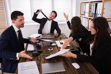 Group Of Frustrated Businesspeople In Meeting