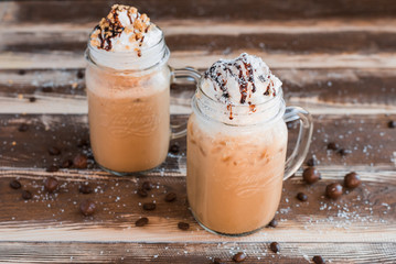 Сoffee with whipped cream on wooden table