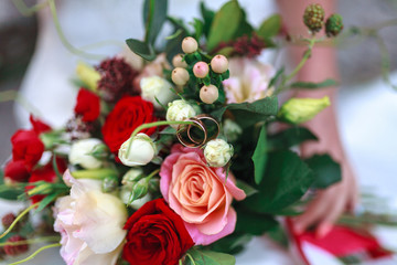 Wedding bouquet of flowers including Red hypericum, Roses, Lilies of the valley, mini Roses, Seeded Eucalyptus, Astilbe, Scabiosa, Pieris, and ivy