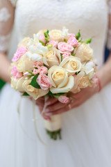 Wedding bouquet of flowers including Red hypericum, Roses, Lilies of the valley, mini Roses, Seeded Eucalyptus, Astilbe, Scabiosa, Pieris, and ivy