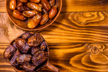 Date fruits on a wooden table. Top view