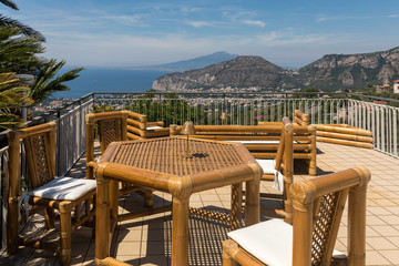 Chairs and table on the terrace overlooking the Bay of Naples and  Vesuvius. Sorrento. Italy