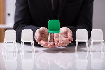 Businessperson Offering Green Seat