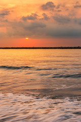 Beautiful early morning sunrise over the sea the horizon at Hat Chao Samran beach in Phetchaburi Thailand.
