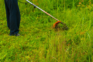 man mowing grass with a lawn mower