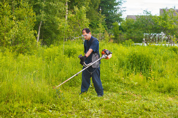 man mowing grass with a lawn mower