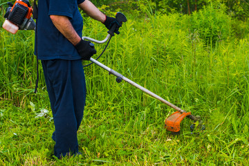 man mowing grass with a lawn mower