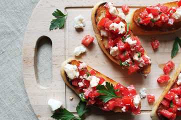 Bruschetta with tomato and mozzarella cheese, decorated with basil