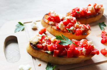 Bruschetta with tomato and mozzarella cheese, decorated with basil