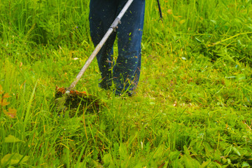 man mowing grass with a lawn mower