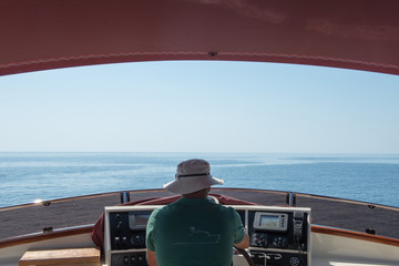 skipper driving a yacht on the sea