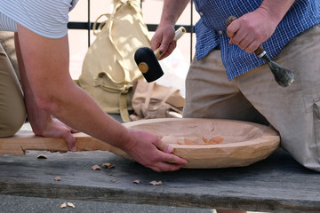 Wood carving. Two masters carve wood crafts product using woodworking tool, hands close up. Carpentry and craftsmanship concept
