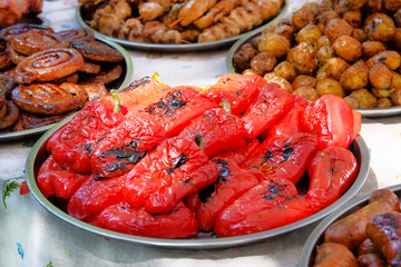 Grilled red pepper in food market on the street. Street food and outdoor cooking concept.