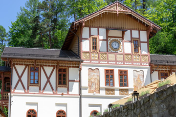 A beautifully renovated building with wooden decorations and paintings on Dietla Square in the health resort Szczawnica Zdrój - obrazy, fototapety, plakaty