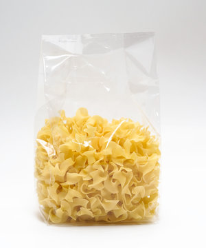 Transparent plastic pasta bag "tagliatelle girate." on white background