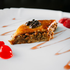 European international fusion cuisine, a beautiful dish on a white plate decorated with herbs and...
