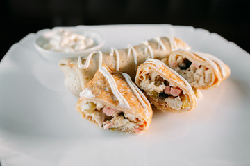 European international fusion cuisine, a beautiful dish on a white plate decorated with herbs and vegetables. a professional chef has prepared a delicious meal.