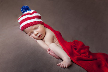Newborn baby wearing a usa flag knitted hat