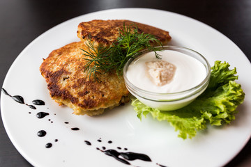 European international fusion cuisine, a beautiful dish on a white plate decorated with herbs and vegetables. a professional chef has prepared a delicious meal.