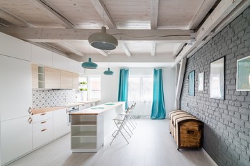 Open bright kitchen with white furniture. Island kitchen.