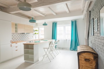 Open bright kitchen with white furniture. Island kitchen.