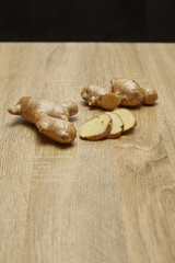 Ginger root sliced on wooden table