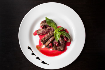 European international fusion cuisine, a beautiful dish on a white plate decorated with herbs and vegetables. a professional chef has prepared a delicious meal.
