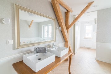 White wash basins in loft bathroom.
