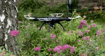 Naklejka premium radio-controlled quadcopter with camera for video and photo shoot speedy orange-red racing on white background isolated