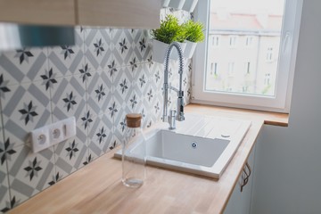 White kitchen sink with chrome faucet