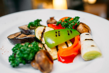 European international fusion cuisine, a beautiful dish on a white plate decorated with herbs and vegetables. a professional chef has prepared a delicious meal.