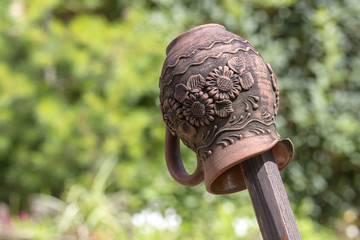 Traditional Ukrainian clay jug on a wooden fence