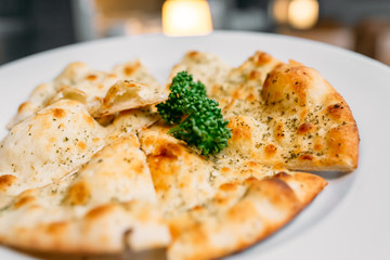 European international fusion cuisine, a beautiful dish on a white plate decorated with herbs and vegetables. a professional chef has prepared a delicious meal.