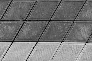 Pavement. Sidewalk tile background. Pavement tile. Top view. Closeup. Footpath. Two tone sidewalk tile. Bicolor. Black and white
