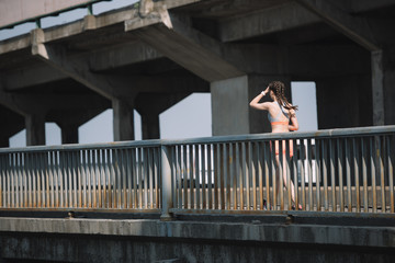Obraz na płótnie Canvas young jogger running on bridge in city