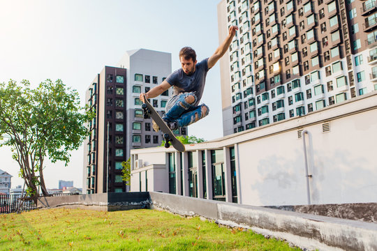 Young man on a skateboard jumping high and making trick