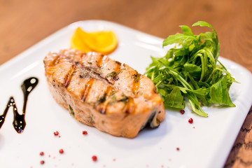 European international fusion cuisine, a beautiful dish on a white plate decorated with herbs and vegetables. a professional chef has prepared a delicious meal.