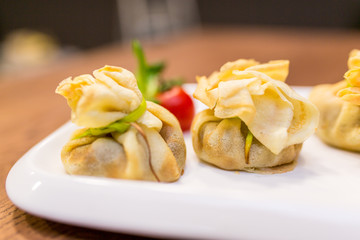 European international fusion cuisine, a beautiful dish on a white plate decorated with herbs and...