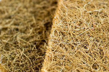 Mattress with coconut fiber. Coconut coir. Grated coconut shell for the production of mattresses. texture, natural background.