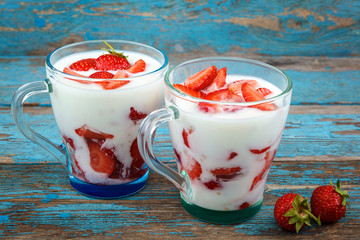 Fresh strawberries with sour cream in a bowl