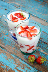 Fresh strawberries with sour cream in a bowl