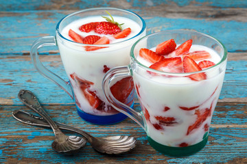 Fresh strawberries with sour cream in a bowl